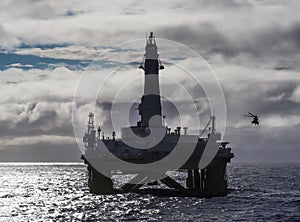 Offshore drilling rig in Gulf of Mexico, petroleum industry, with helicopter