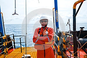 Offshore engineer, standing on the deck of an industrial ship