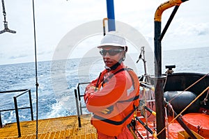 Offshore engineer, standing on the deck of an industrial ship