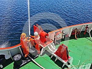 Offshore marine crew doing fire fighting testing at forward ship