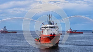 An offshore marine vessel doing FiFi testing or fire fighting training.