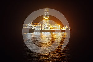 Offshore oil drillship at night