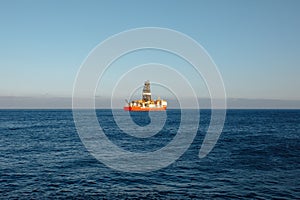 Offshore oil and gas drillship, blue ocean background