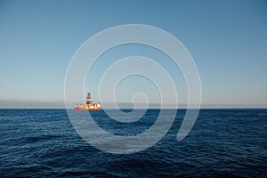 Offshore oil and gas drillship, blue ocean background