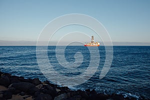 Offshore oil and gas drillship, blue ocean background