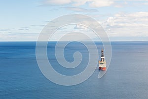 Offshore oil and gas drillship, blue sea background