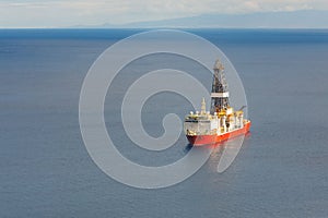 Offshore oil and gas drillship, blue sea background