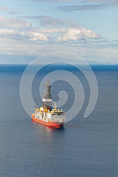 Offshore oil and gas drillship, blue sea background