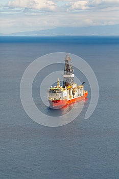 Offshore oil and gas drillship, blue sea background