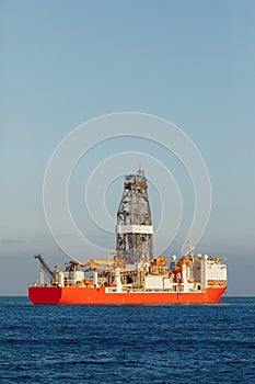 Offshore oil and gas drillship, blue sea background, aerial view