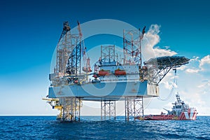 Offshore oil and gas jackup drilling rig work over remote wellhead platform to completion oil and gas produce well .