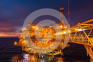 Offshore oil and gas rig platform with beautiful sunset time or