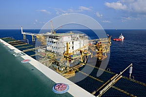 The offshore oil rig platform and supply boat