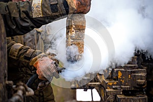 Offshore oil rig worker prepare tool and equipment for perforation oil and gas well at wellhead platform. Making up a drill pipe