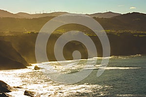 Offshore rocks and coastline in sunny day