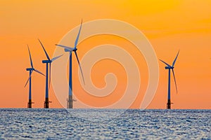 Offshore wind farm energy turbines at dawn. Surreal but natural photo
