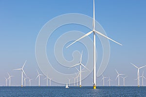 Offshore wind farm with many windmills, the Netherlands with sailboat