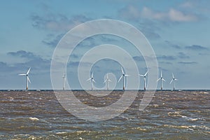 Offshore wind farm turbines. Clean energy and sustainable resource development.
