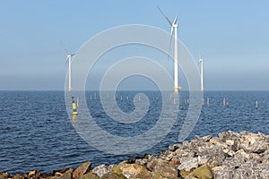 Offshore wind turbines near Dutch coast with buoy