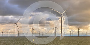 Offshore Windfarm at sea under cloudy sky