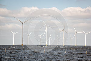 Offshore Windmill farm in the ocean Westermeerwind park , windmills isolated at sea on a beautiful bright day