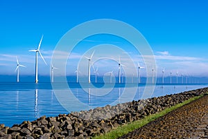 offshore windmill park with clouds and a blue sky, windmill park in the ocean drone aerial view with wind turbine