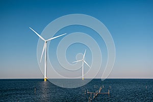 Offshore windmill park green energy in the Netherlands Europe, wind mill turbines at sea and land providing green energy