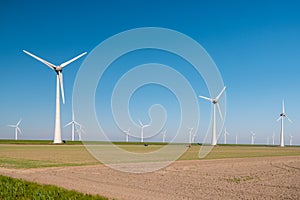 Offshore windmill park green energy in the Netherlands Europe, wind mill turbines at sea and land providing green energy