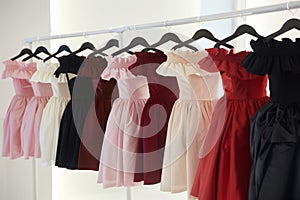 offtheshoulder dresses lined up on a sleek rack