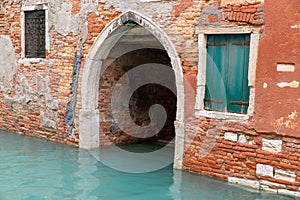 Ogive arched entrance of a venetian building on a canal, Venice, Italy