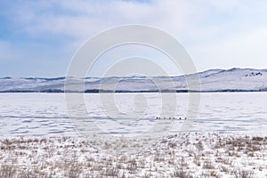 Ogoy island winter landscape. View of the mountains and frozen Lake Baikal on a winter day