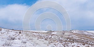 Ogoy island winter landscape. View of the mountains and frozen Lake Baikal on a winter day