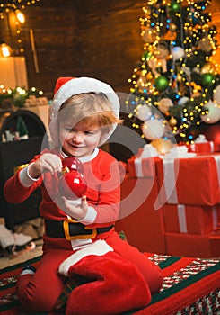 Oh happy day. Joy and happiness. Childhood moments. Kid boy santa hold christmas gift. Christmas stocking concept. Child