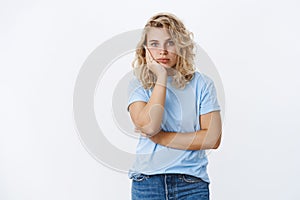 Oh my god distaster. Portrait of shocked girl in stupor leaning on palm and staring speechless at camera as being photo