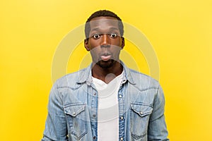 Oh my god! Portrait of astonished handsome man shocked by unbelievable news. indoor studio shot isolated on yellow background