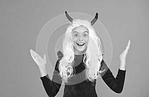 oh my god. surprised child in devil horns. kid has long white hair wig. childhood happiness. teen girl ready to