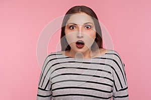 Oh my god, wow! Portrait of surprised woman in striped sweatshirt standing with open mouth, expressing amazement