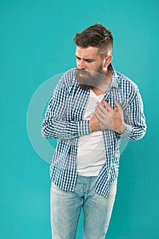 Oh my heart. Bearded man suffer from heart pain. Hipster hold hand on heart. Cardiovascular health. Heartache and chest
