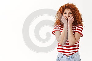 Oh no scared. Innocent timid redhead curly woman blue eyes panicking look concerned frightened hold hands mouth biting