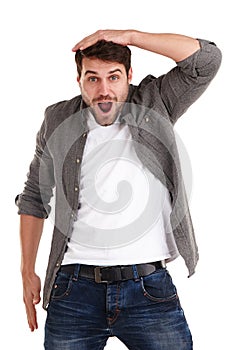 Oh no you didnt. Studio shot of a young man holding his head and looking with amazement at the camera.