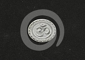 ohm symbol silver metal coin. photo