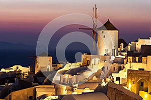 Oia at dusk, with beautiful windmill, Santorini island, Greece