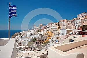 Oia panorama and Greek flag