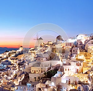 Oia at sunset. Beautiful view of the village of Oia, Santorini, Greece, Aegean sea, Europe. Classic white Greek architecture,