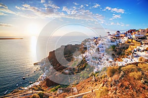 Oia town on Santorini island, Greece at sunset. Famous windmill