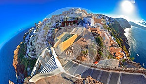 Oia town on Santorini island, Greece. Traditional and famous houses and churches with blue domes over the Caldera.