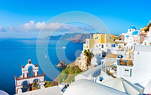 Oia town on Santorini island, Greece. Traditional and famous houses and churches with blue domes over the Caldera.