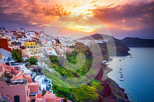 Oia town on Santorini island, Greece. Traditional and famous houses and churches with blue domes over the Caldera.