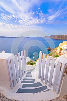 Oia town on Santorini island, Greece. Traditional and famous houses and churches with blue domes over the Caldera.