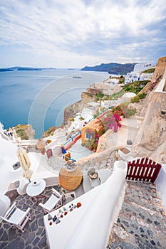 Oia town on Santorini island, Greece. Traditional and famous houses and churches with blue domes over the Caldera.